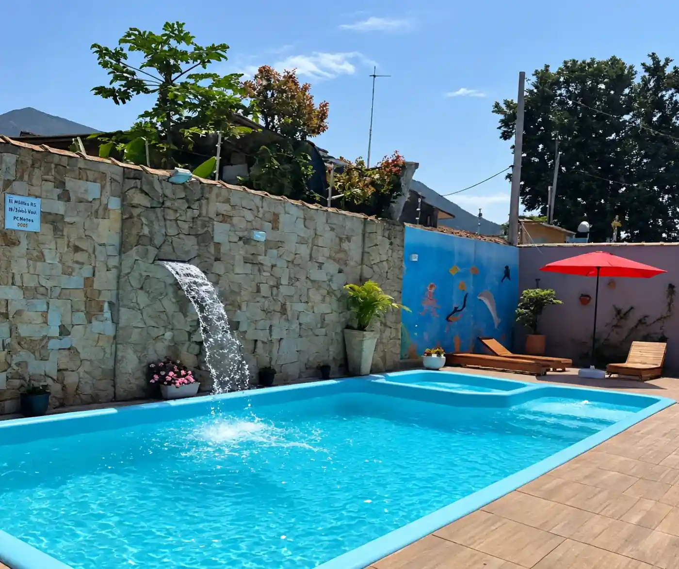 Main outdoor swimming pool with loungers and umbrellas